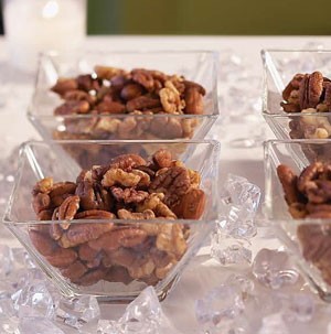 Square glass bowls filled with roasted mixed nuts