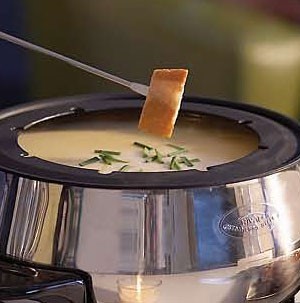 Cubed Bread dipped into Cheese Fondue