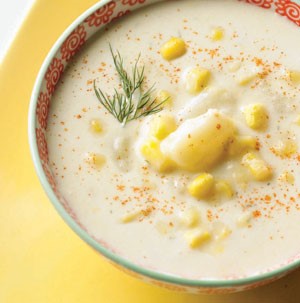 Bowl of Corn and Potato Soup, garnished with fresh Dill and Cayenne Pepper