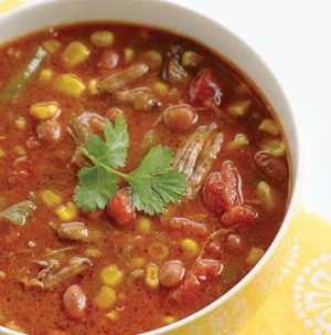 Bowl of beef tortilla soup garnished with cilantro