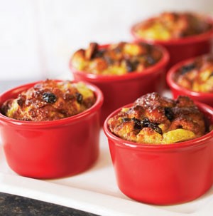 Small red ceramic bowls filled with baked bread pudding
