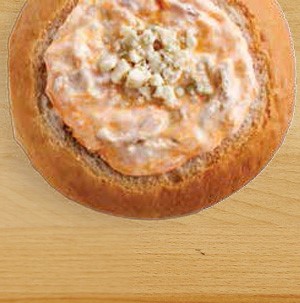 Bread bowl filled with buffalo blue cheese chicken dip