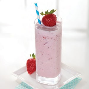 Blended strawberry smoothie, served in a tall glass and garnished with a fresh strawberry and a straw