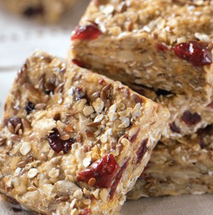 Oat and chia seed stacked square bars packed with dried fruit and sunflower seeds