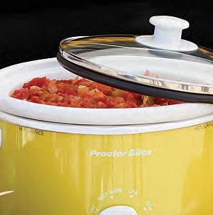 Yellow slow cooker filled with marinara sauce