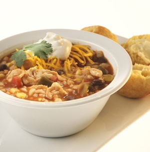 Bowl of Chicken Chili garnished with Cilantro, Cheese and Sour Cream