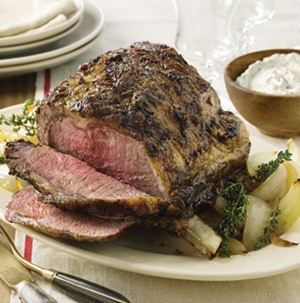Plate of prime rib served with a side of horseradish