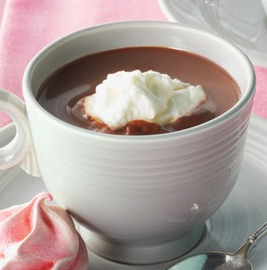White mug filled with hot chocolate with whipped cream on top
