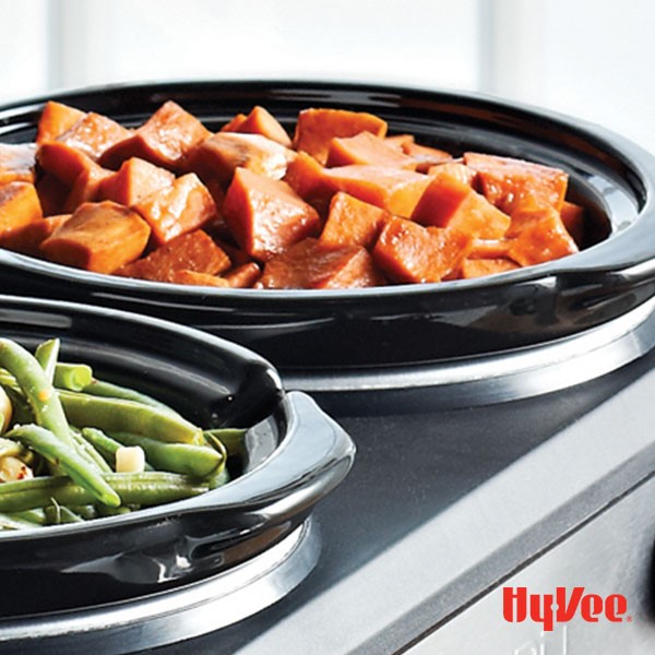 A slow-cooker filled with fresh green beans and a slow-cooker filled with sweet potato chunks