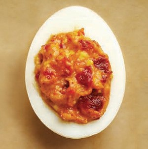 Smoky deviled egg filled with sundried tomatoes