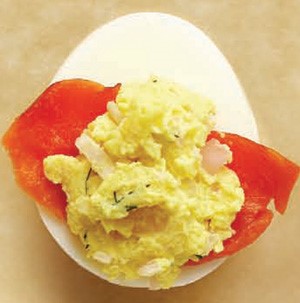 Deviled egg filled with salmon slice and wasabi filling