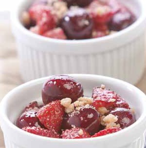 Small white ceramic bowls filled with berry cherry cobbler