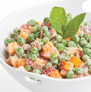 White bowl of cheddar cheese pea salad