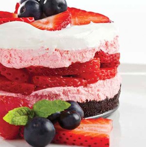 Chocolate-Oreo crust layered with strawberry-flavored cream cheese filling, fresh strawberries and whipped topping