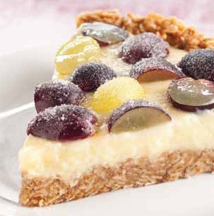 Oatmeal crusted creamy filled tart with sugared grapes on top
