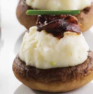 Whole mushrooms filled with mashed potatoes and topped with caramelized onions and fresh chive