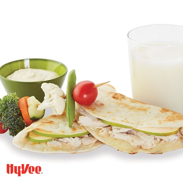 Apple chicken quesadillas next to skewered vegetables and side of dipping sauce
