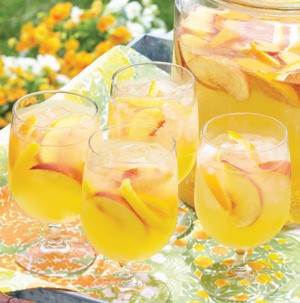 Four glasses of sangria with peach slices