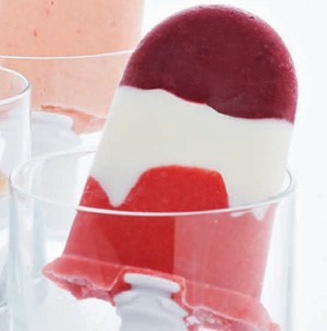 Pink, white and purple berry yogurt pop in a clear glass
