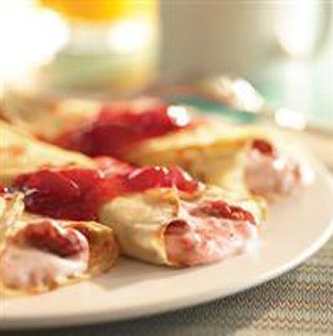 Crepes filled with strawberry cream and topped with strawberry sauce