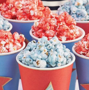Blue and red colored popcorn in red and blue paper cups