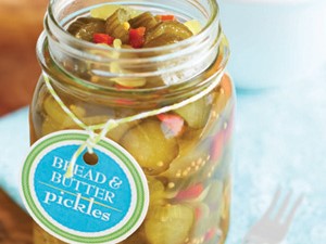 Mason jar filled with bread and butter pickles attached to a homemade label
