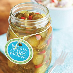 Mason jar filled with bread and butter pickles attached to a homemade label