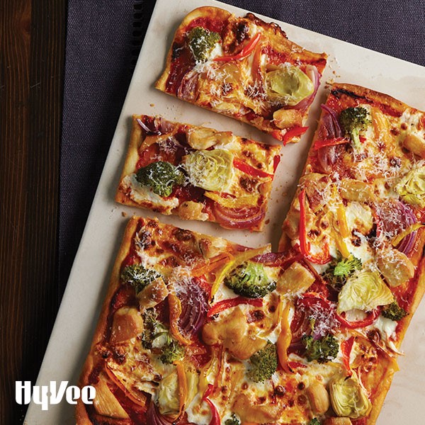 Chicken-vegetable pizza on parchment paper