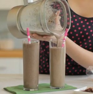 Chocolate shake in tall thin glasses with pink and white polka dot straws
