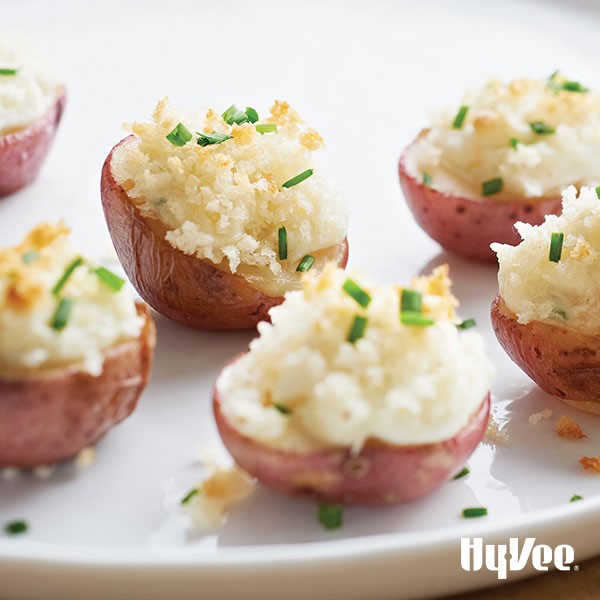 Plate of potatoes stuffed with blue cheese and topped with breadcrumbs and green onions