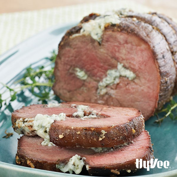 Blue platter of eye-of-round roast stuffed with blue cheese