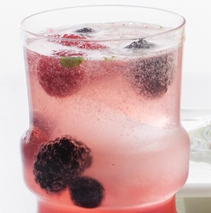 Glass of berry Christmas dazzler with fresh blackberries and raspberries