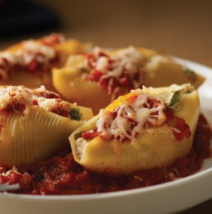 Jumbo pasta shells filled with ricotta and topped with tomato sauce and melted Italian cheese