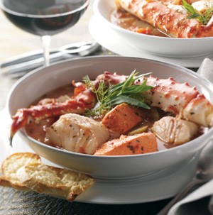 Bowl of broth with Alaska crab and mixed seafood