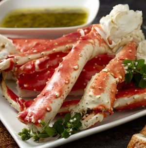 Plate of crab legs with side of dipping sauce