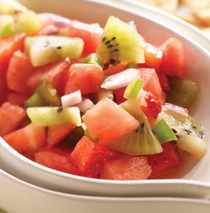 Chopped watermelon, kiwi, and strawberries in a white bowl