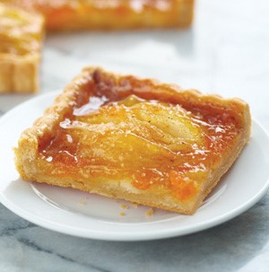 Slice of apple and pear tart on a white plate