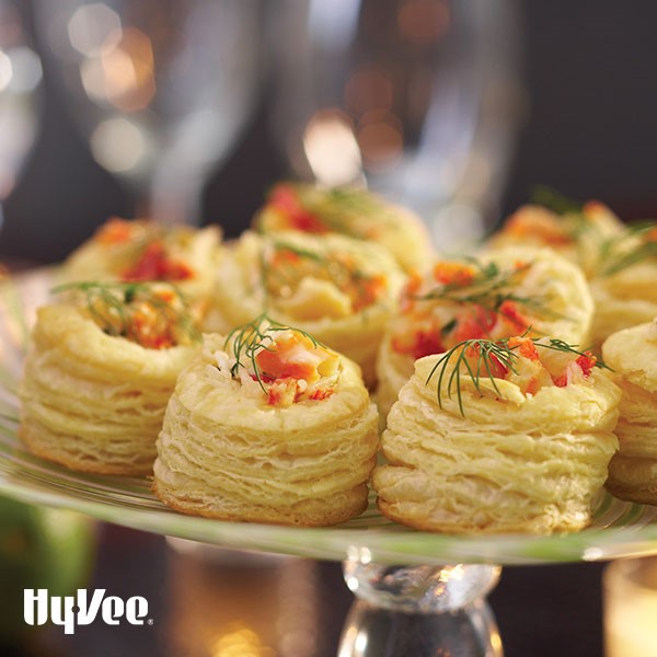 Platter of crab and brie puffs, garnished with fresh dill