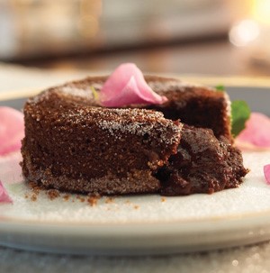 Molten chocolate lava cakes with piece missing and soft chocolate oozing out