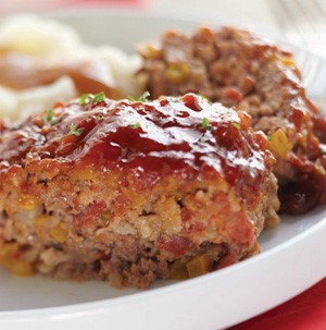 Meatloaf slices with sauce and thyme leaves