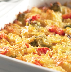 Casserole dish filled with cheesy vegetables and rice