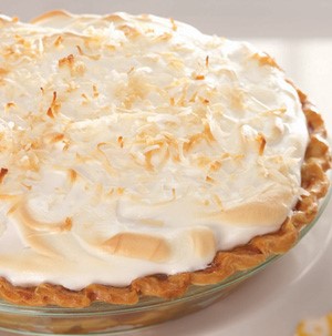 Coconut cream pie topped with toasted coconut flakes