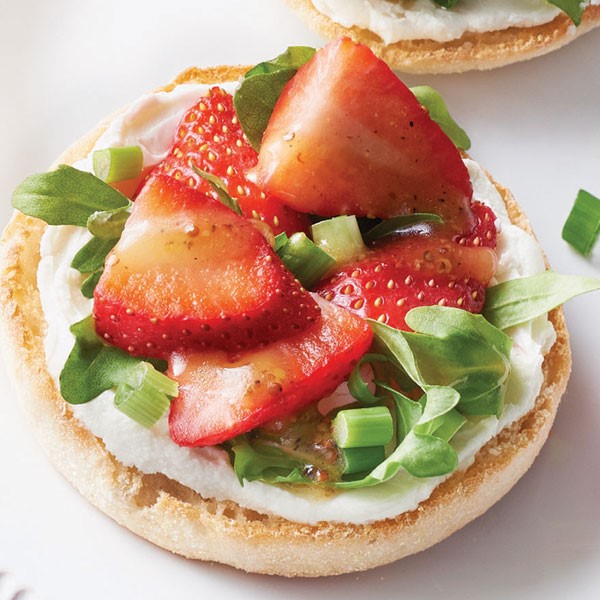 English muffin topped with goat cheese, arugula, green onion and strawberries