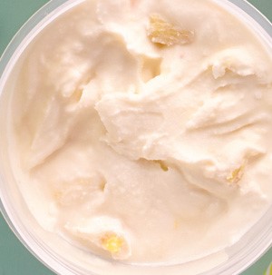 Light pink mango-pineapple ice cream in a plastic container