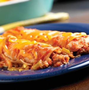 Beef enchiladas covered in cheese on a blue plate