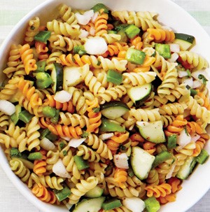 Red, green, and white spiral pasta mixed with green peppers and onions