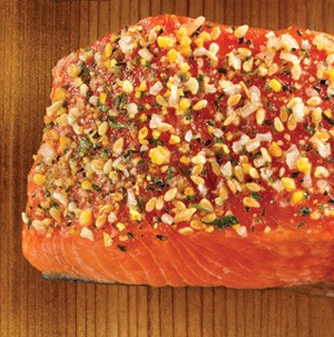 Seasoned salmon on wooden plank