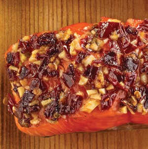 Seasoned salmon on wooden plank