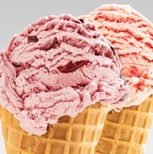 Waffle cones filled with red fresh fruit ice cream