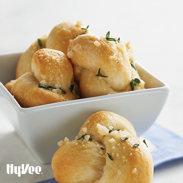 Knoted bread topped with minced garlic and thyme